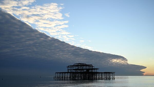 Облака, напоминающие огромную волну, над пляжем в Брайтоне на юге Англии - Sputnik Абхазия