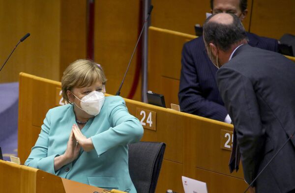 Канцлер Германии Ангела Меркель во время приветствия локтем на пленарной сессии Европейского парламента в Брюсселе  - Sputnik Абхазия