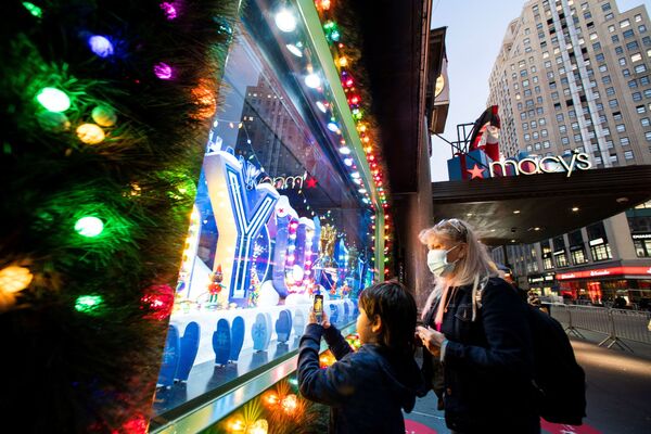 Люди фотографируют рождественскую витрину в магазине Macy's Herald Square в Нью-Йорке - Sputnik Абхазия