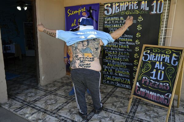Производитель пиццы Гильермо Родригес, крещенный в церкви Марадоны, демонстрирует татуировку на спине, Мерло, Аргентина - Sputnik Абхазия