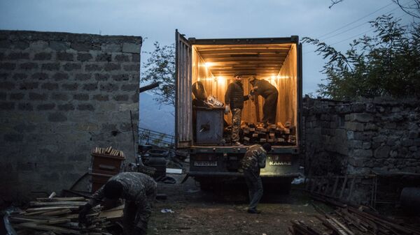 Местные жители загружают личные вещи в грузовик в поселке Карегах - Sputnik Абхазия