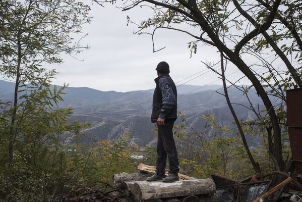 Мужчина смотрит на горы возле своего дома в поселке Карегах - Sputnik Абхазия