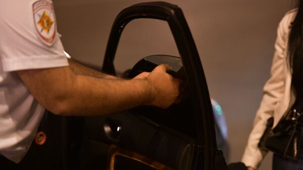 Сотрудник ДПС снимает тонировку автомобиля  - Sputnik Аҧсны