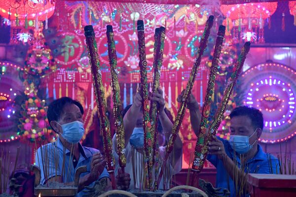 Верующие с ароматическими палочками в храме во время Нового года по лунному календарю в Такмау, Камбоджа - Sputnik Абхазия