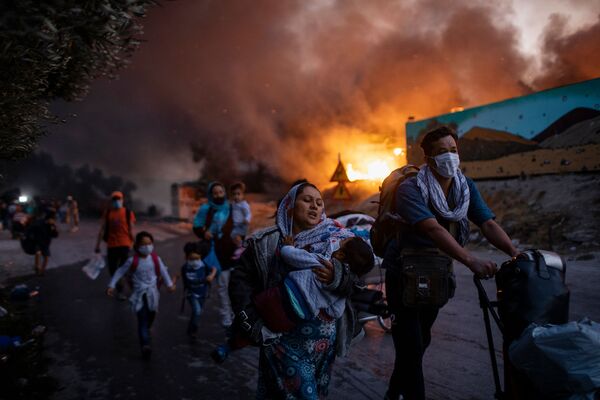 Снимок из серии Fleeing a Fire Burning Refugee Camp греческого фотографа Petrosa Giannakouris, ставшим третьим в категории Single News конкурса Istanbul Photo Awards 2021 - Sputnik Абхазия