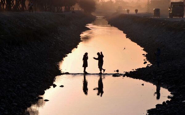 Афганские дети пересекают канал на окраине Джелалабада. - Sputnik Абхазия