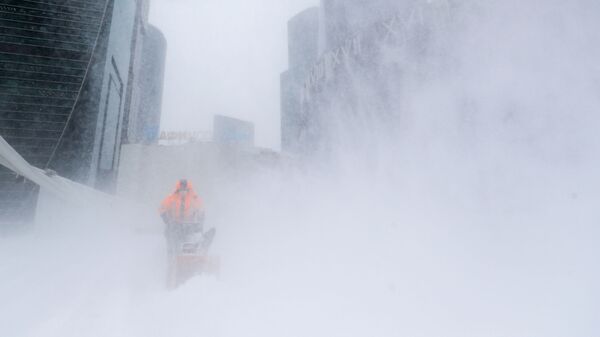 Сотрудник коммунальной службы убирает снег с площади у делового центра Москва-сити - Sputnik Аҧсны