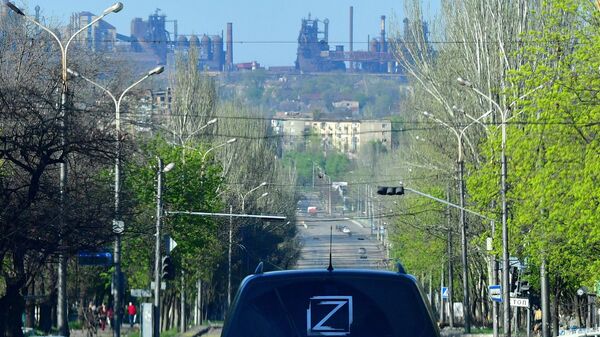Машина со знаком Z на одной из улиц в Мариуполе. На дальнем плане - завод Азовсталь - Sputnik Абхазия