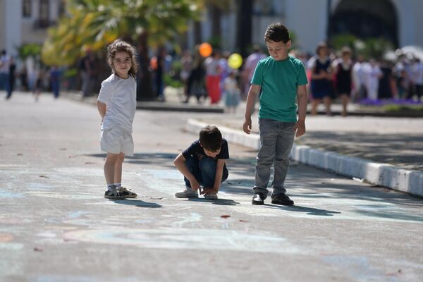 Детям на набережной выдавали цветные мелки... - Sputnik Абхазия