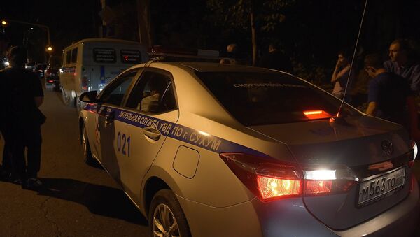 Машина МВД на месте убийства Виталия Асландзия. Фото с места события - Sputnik Абхазия