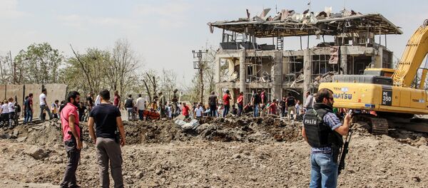 Сотрудники турецкой полиции и спасателей на месте взрыва бомбы у отделение полиции на востоке Турции Сотрудники турецкой полиции и спасателей на месте взрыва бомбы у отделение полиции на востоке Турции - Sputnik Абхазия