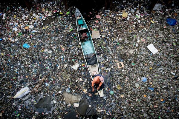 Работник собирает мусор с реки Марилао в Булакан, к северу от Манилы, 18 марта 2017 года - Sputnik Абхазия