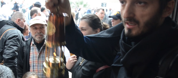 Абхазские паломники с Благодатным огнем выехали из Иерусалима в Абхазию Абхазские паломники с Благодатным огнем выехали из Иерусалима в Абхазию - Sputnik Абхазия