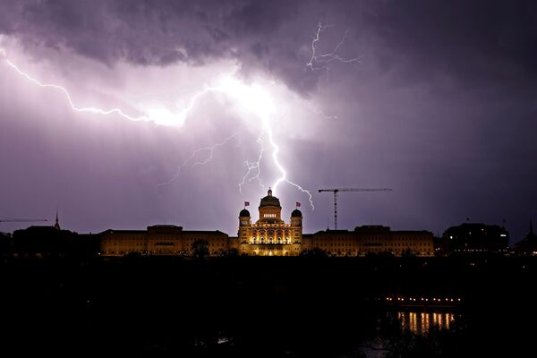 Сверкающие молнии над швейцарским федеральным дворцом в Берне, Швейцария - Sputnik Абхазия