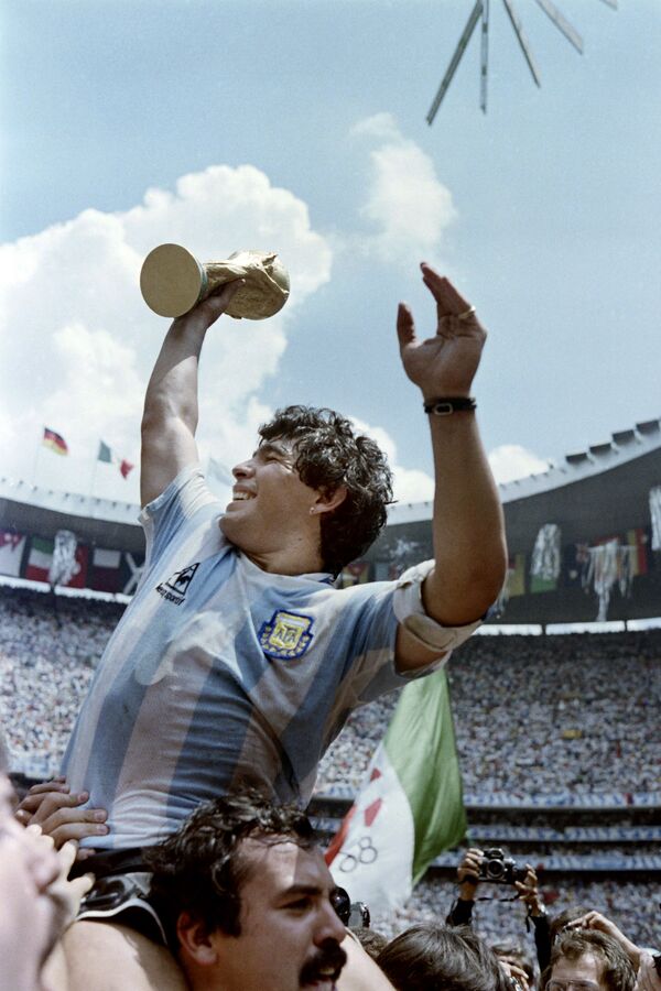 Капитан сборной Аргентины Диего Марадона с Кубком мира по футболу после победы в матче с Западной Германией, 1986 год - Sputnik Абхазия