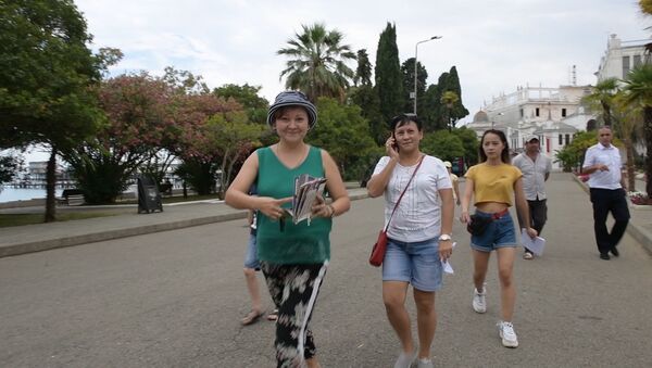 Люди что-то ищут в жару на улицах столицы Абхазии - Sputnik Абхазия