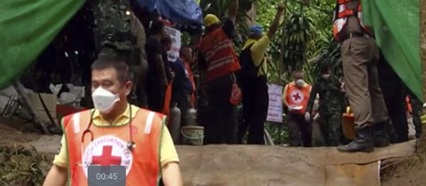 Спасатели несут носилки с предполагаемым спасенным ребенком из затопленной пещеры Тхам Луанг в Таиланде Спасатели несут носилки с предполагаемым спасенным ребенком из затопленной пещеры Тхам Луанг в Таиланде - Sputnik Абхазия