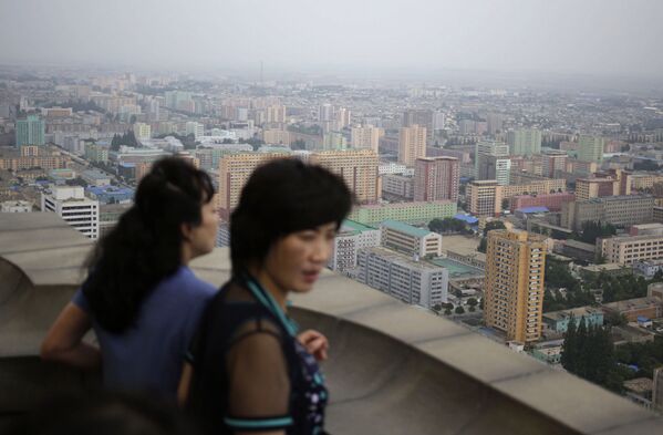 Северокорейские женщины наслаждаются пейзажем с вершины Монумента идей чучхе в Пхеньяне, Северная Корея - Sputnik Абхазия