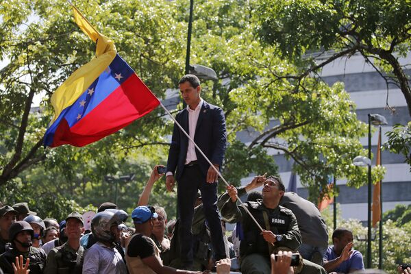 Лидер оппозиции Венесуэлы и самопровозглашенный президент Хуан Гуайдо выступает перед сторонниками у военной авиабазы Ла-Карлота в Каракасе - Sputnik Абхазия