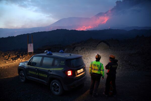 Сотрудники итальянской налоговой полиции наблюдают за извержением вулкана Этна на Сицилии - Sputnik Абхазия
