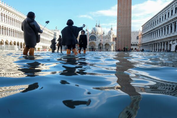 Туристы фотографируются на площади Сан-Марко во время наводнения в Венеции - Sputnik Абхазия