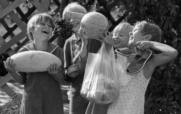 Воспитанники Ташкентского детского дома держат в руках дыню, арбуз, виноград и персики, которые они сами вырастили на своем приусадебном участке, 1983 год - Sputnik Абхазия