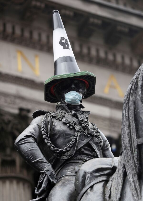 Конная статуя герцога Веллингтона с дорожным конусом на голове и с маске после акций протеста в Глазго, Великобритания - Sputnik Абхазия